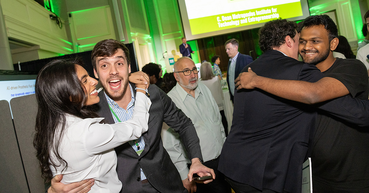 Students and friends celebrate and hug after winning the competition