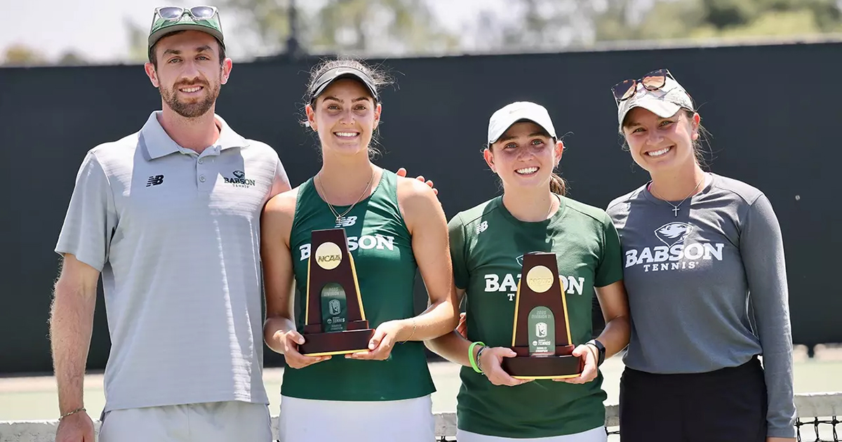 The champion tennis players pose for a photo with their trophies alongside their coaches