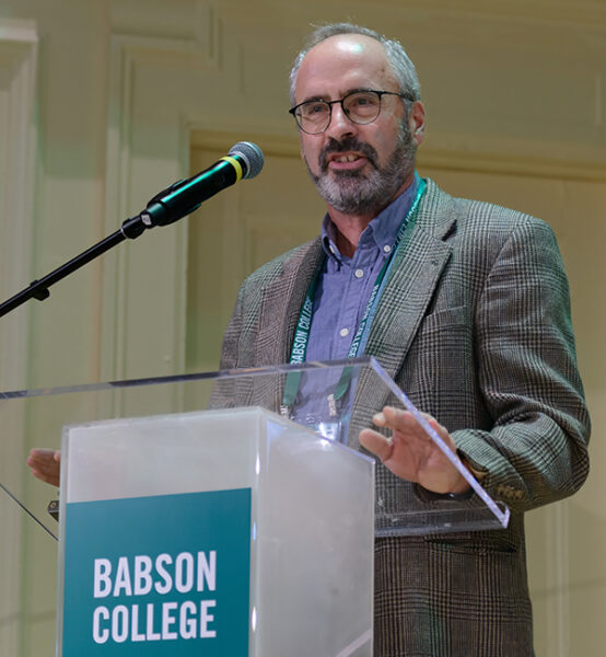Andrew “Zach” Zacharaki speaks at a podum