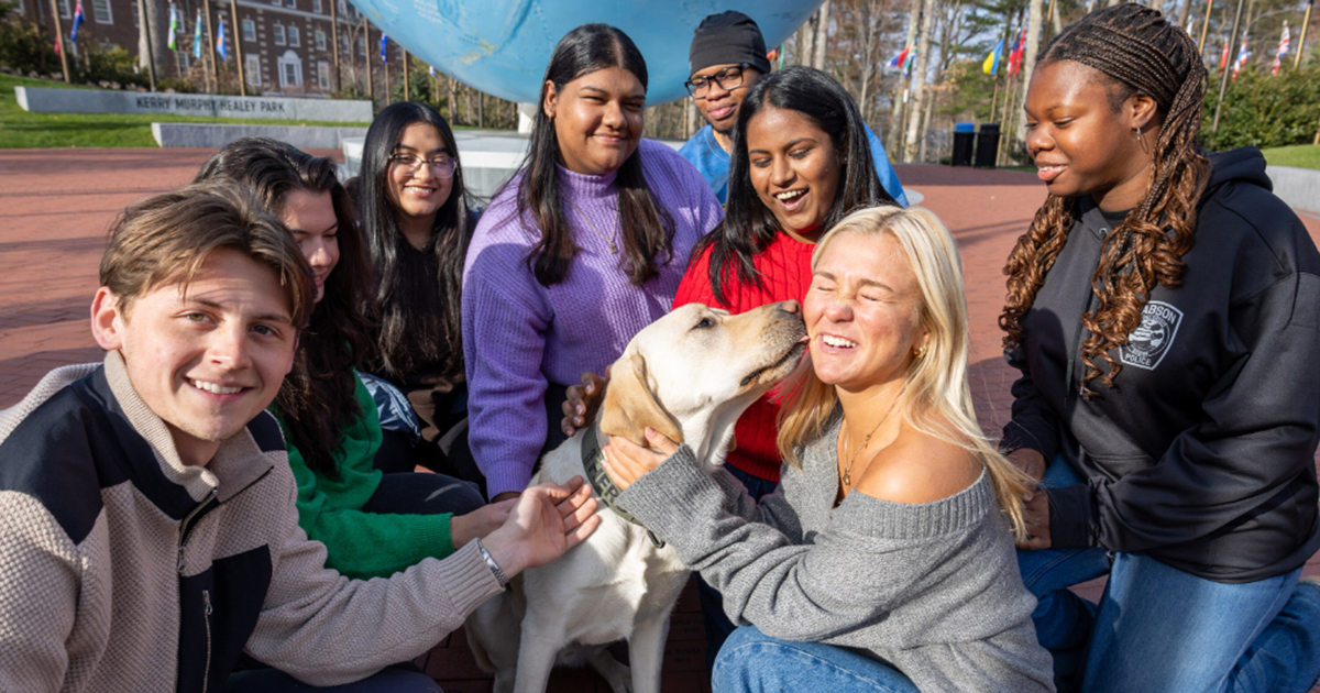 Public safety dog surrounded by students.