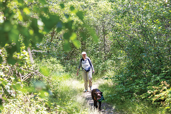 Katherine "Gig" Babson and her dog hike the trail of boulders