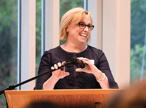 Gerri Randlett speaks behind a podium at an event