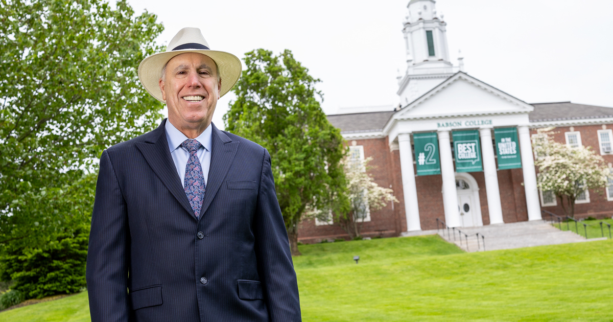 President Spinelli poses for a portrait on campus in front of Tomasso Hall