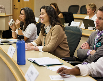 Students smile while listening during a classroom session
