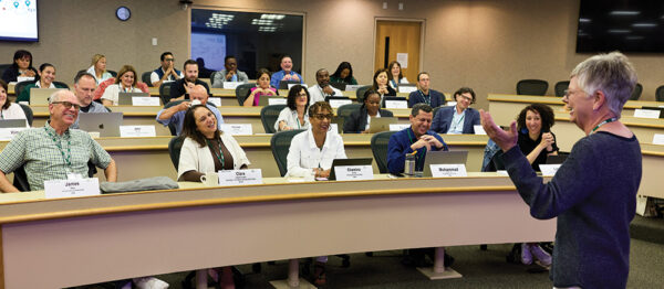 Heidi Neck gestures while speaking in a classroom during the Price-Babson Symposium for Entrepreneurship Educators program