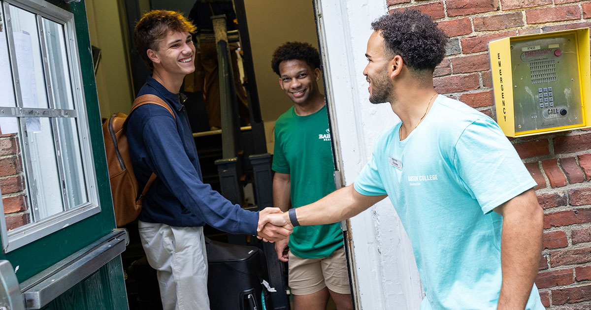 Juan “JC” Grullon ’27 and Ty Bradford ’29 shake hands outside Publishers Hall