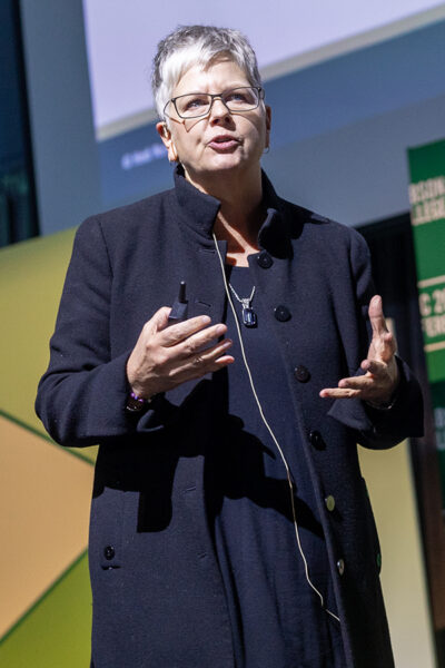 Heidi Neck motions while speaking on stage