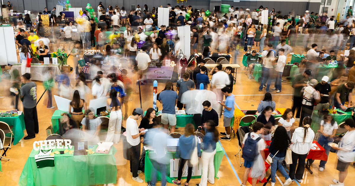An overview of the fair with students in a blur as the move around