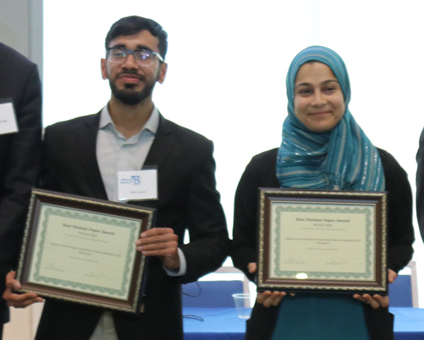 Talha Gulzar and Nada Hashmi pose for a photo with their awards