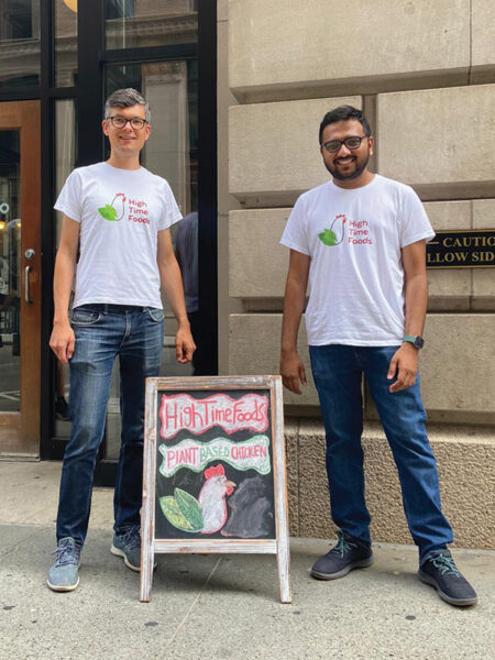 Aakash Shah and Damian Felchlin pose outside next to a sign board for High Time Foods