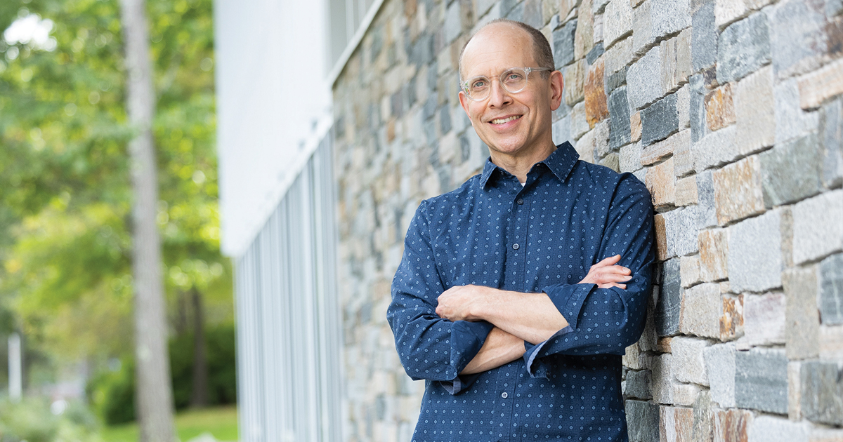 Craig Bida poses for a photo outside on campus