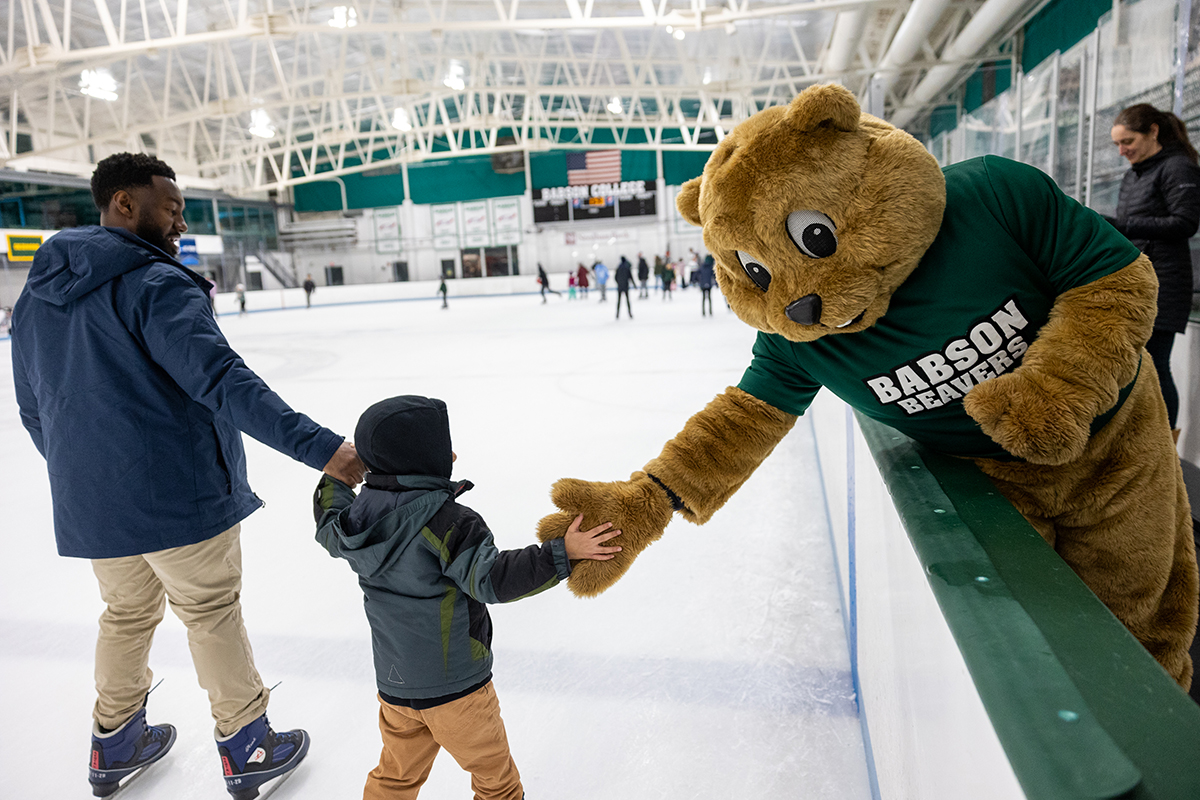 Biz E. Beaver greats a young skater at the family skate at the Babson Skating Center in February. (Photo: Nic Czarnecki/Babson College)