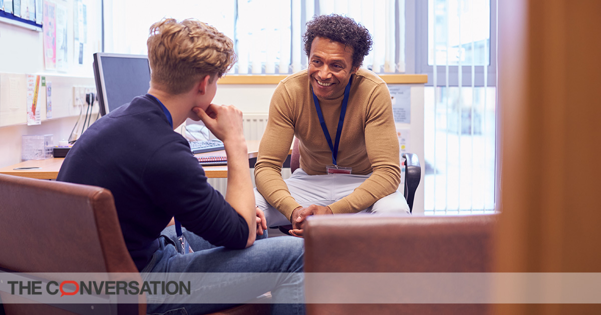 Male college student meets with campus counselor