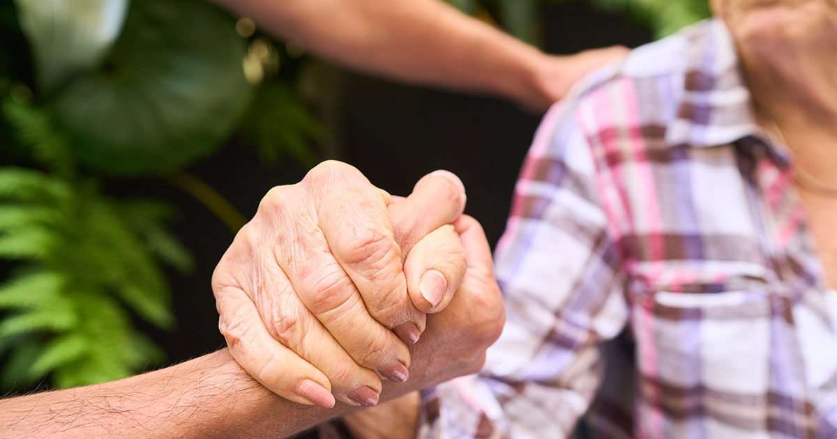 two people hold hands