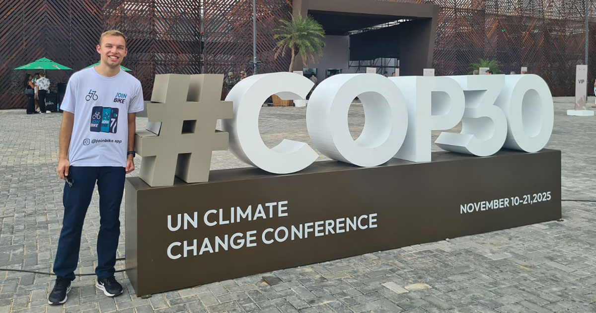 Gustavo Augusto Kopp de Lima ’28 stands next to a sign for the COP 30 climate change conference