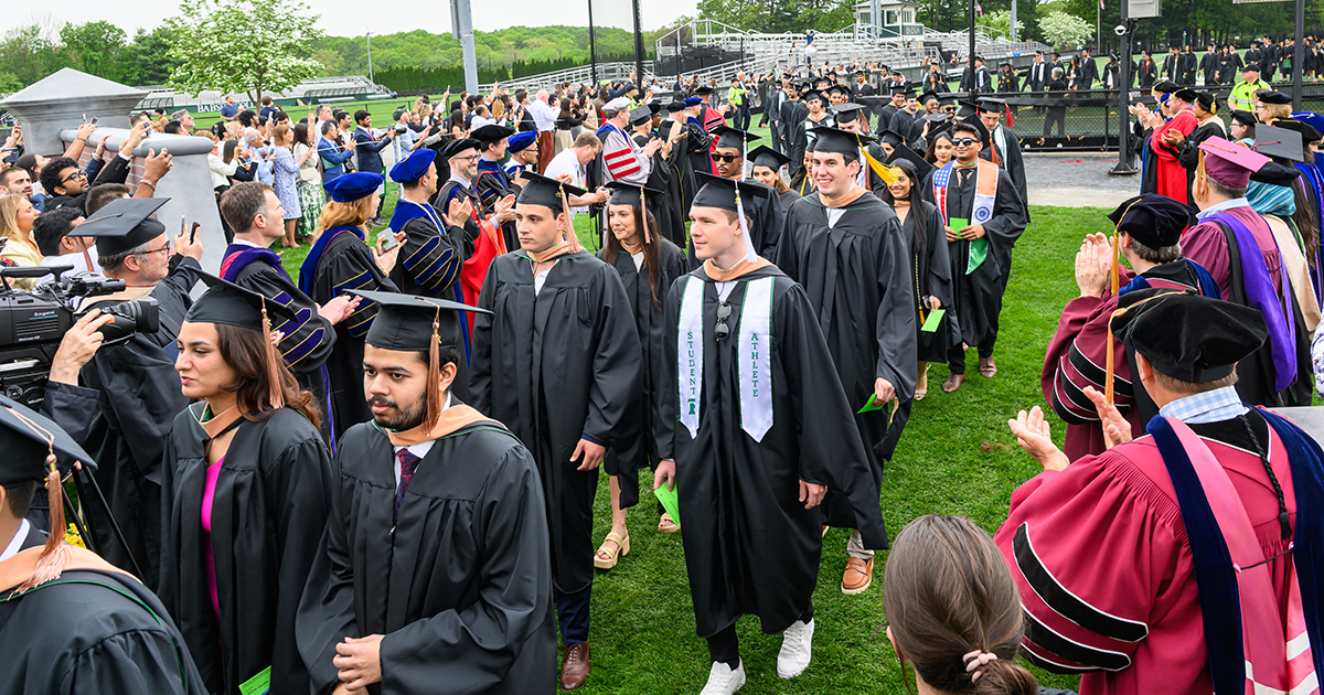 Graduates walk during the Commencement ceremony