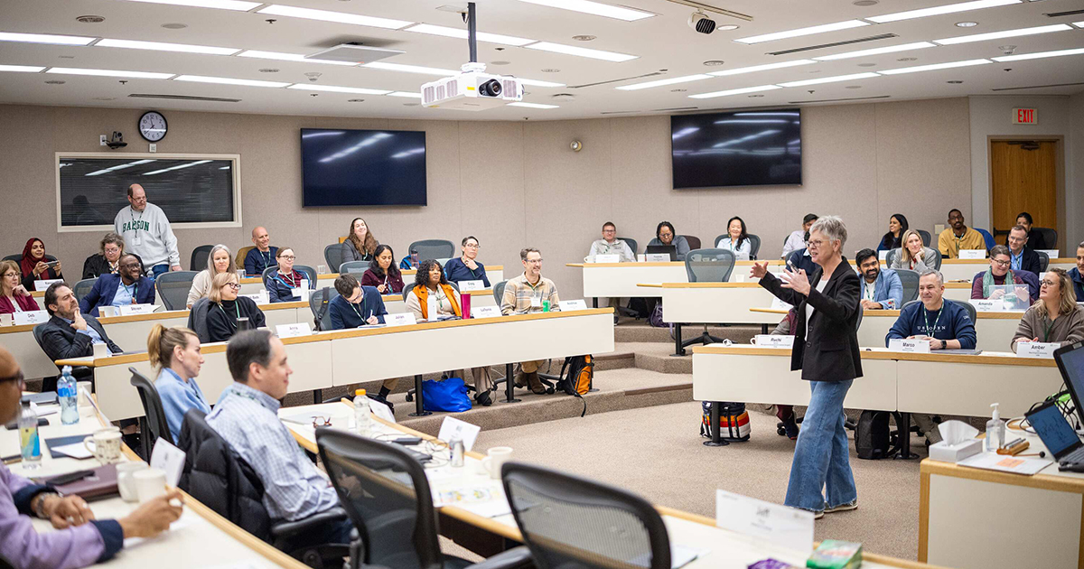 Babson teacher stands in front of class teaching entrepreneurship to faculty from around the world.