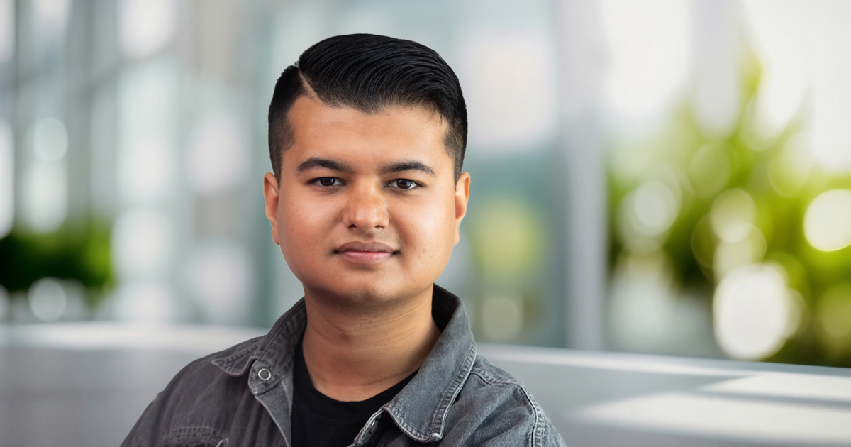Headshot of Pranit Chand set against a blurred office background