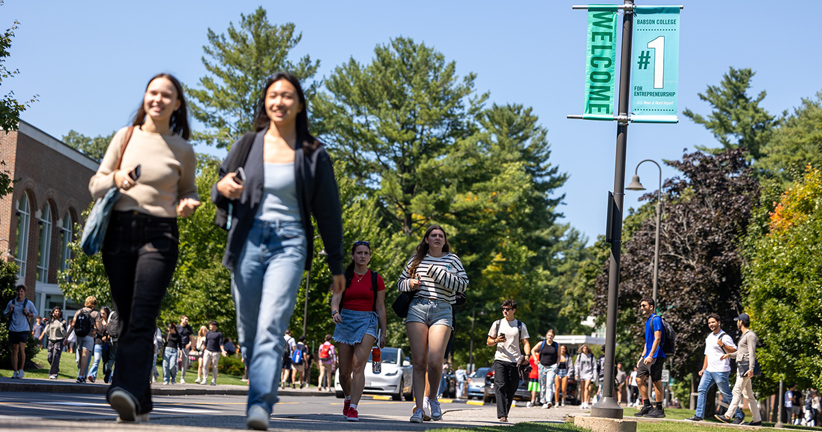 Students walk on campus under a number one banner