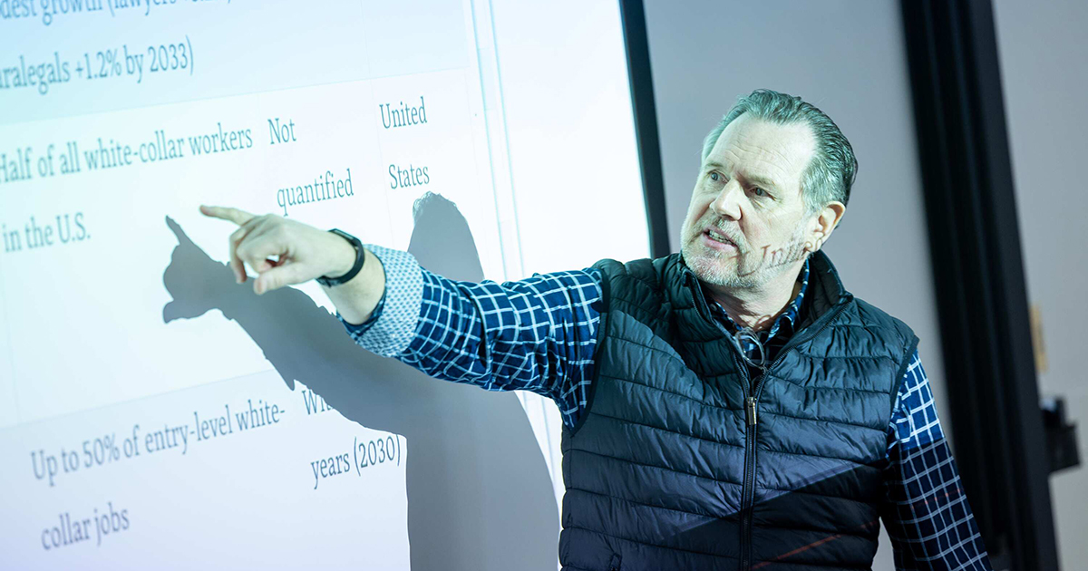 Babson professor points to research findings during presentation.