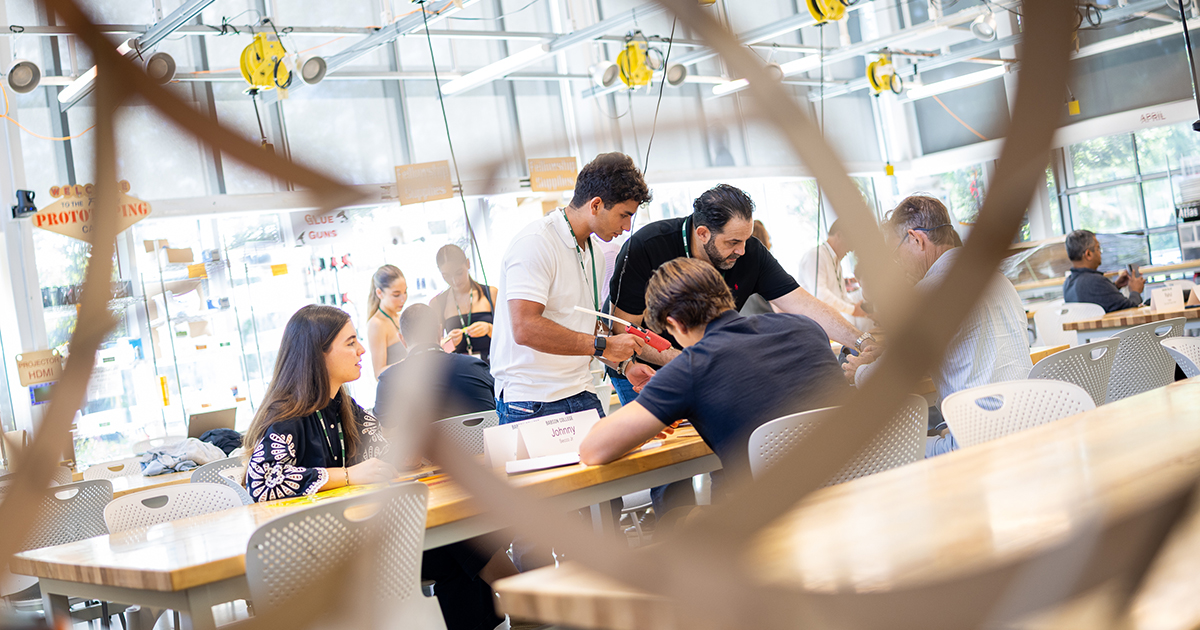 Entrepreneurs collaborate at a table during an Entrepreneurial Family event at the Foundry