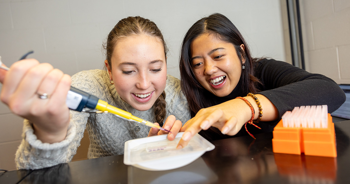 Two students work together on a lab project