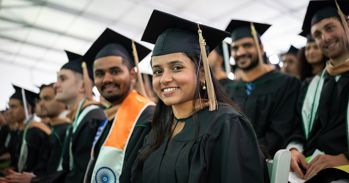 Graduates smile during the Commencement ceremony