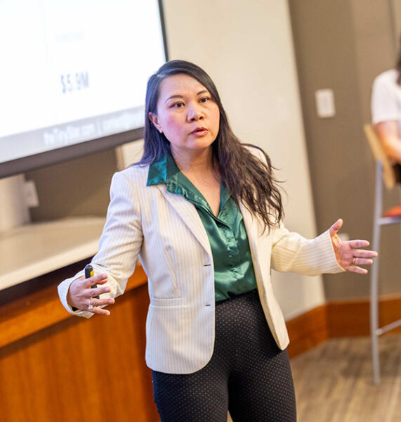 A woman pitches her company during a contest.