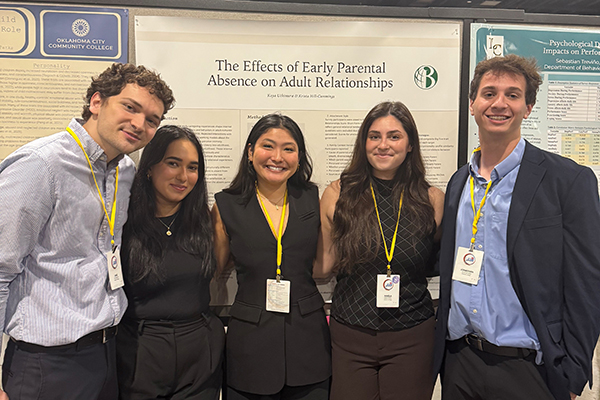 A group of five students poses for a photo