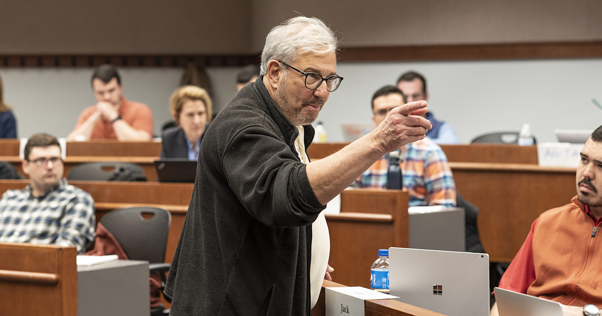 Man gesturing while teaching in Babson classroom.