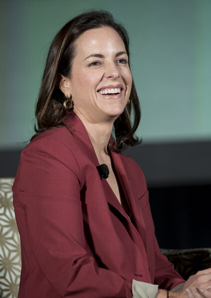 Adriana Cisneros smiles while on stage at an event