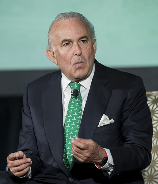 Gustavo Cisneros gestures while speaking at an event