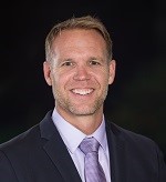 A smiling man who is a finance professor at Babson.