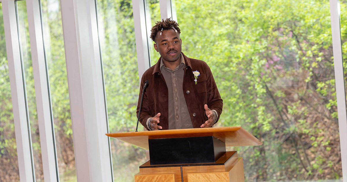 A man speaking at a lectern.