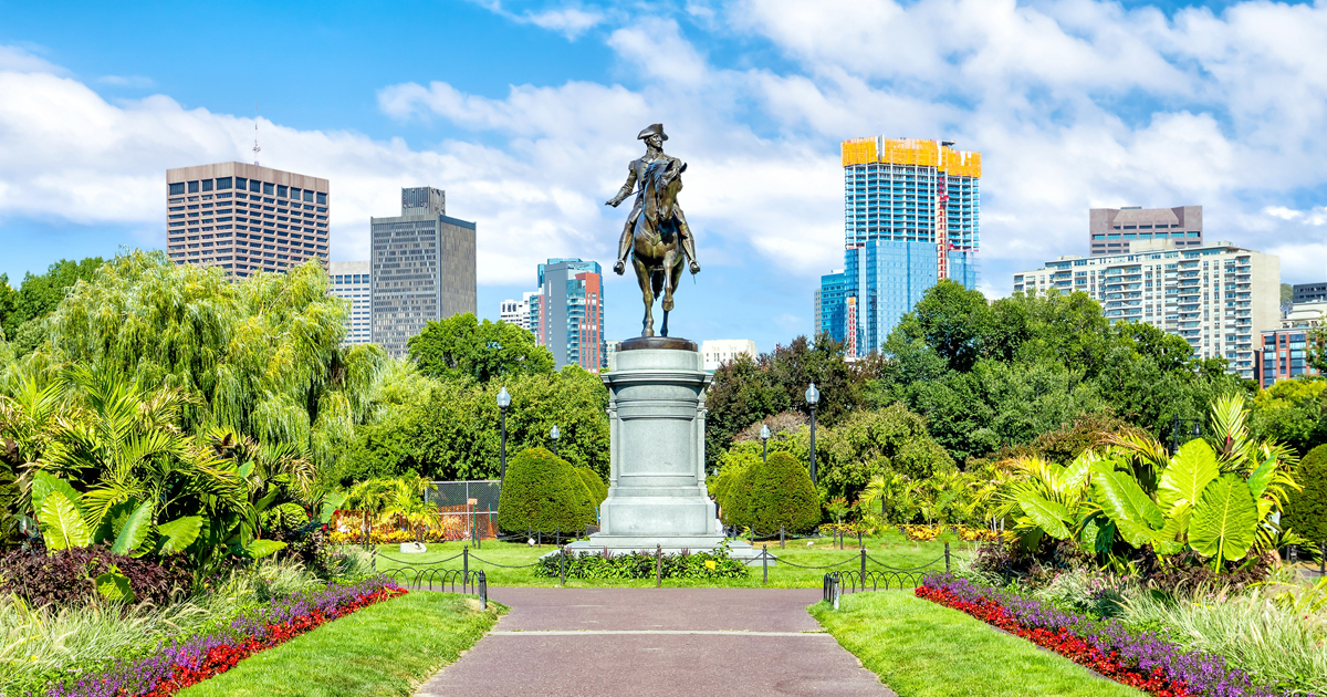 A picturesque view of Boston's Public Gardens with a statue of George Washington on horseback in the center
