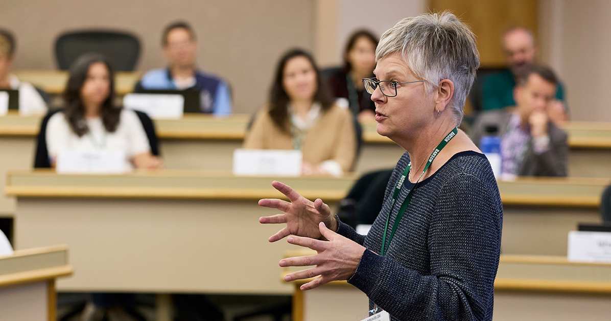 Heidi Neck gestures while speaking in front of a classroom