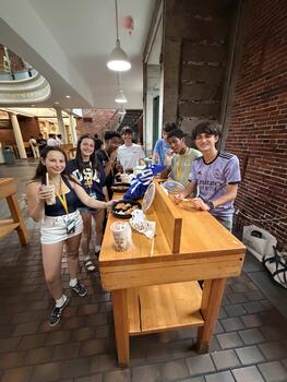 Young people eating at Faniuel Hall as part of a summer program.