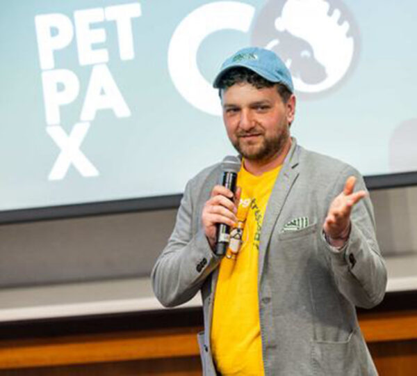 Man speaking with microphone about his pet wellness venture.