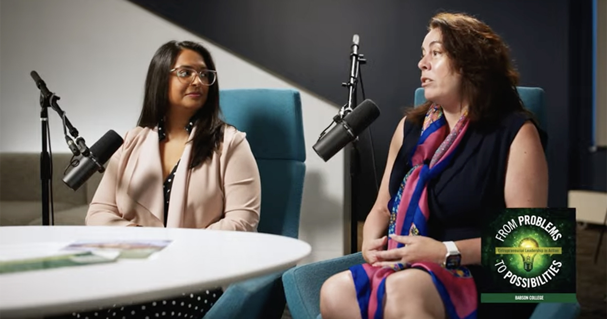 Kristi Girdharry and Patty Patria talk while seated at a table