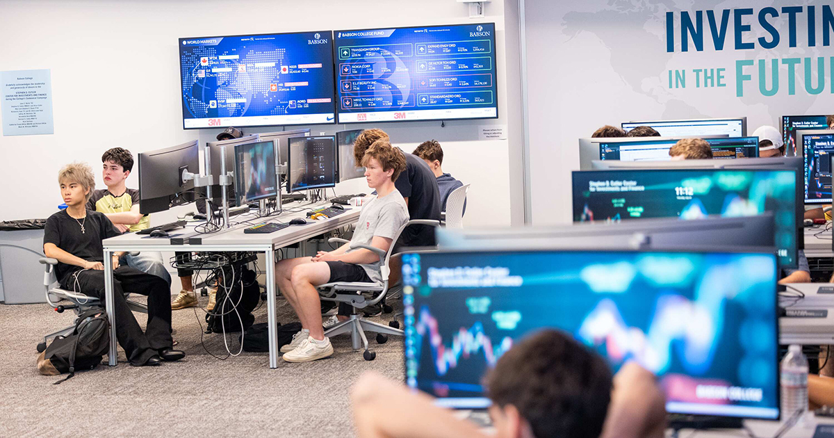 Students sit at work stations in the finance lab