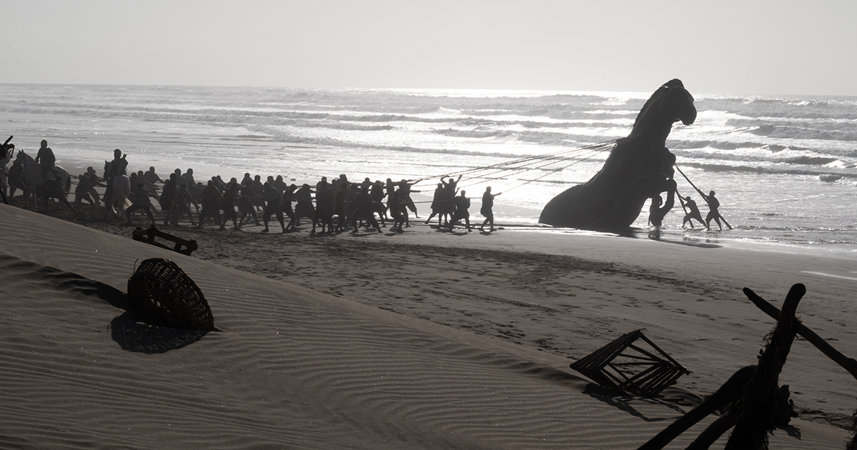 In a scene from the movie The Odyssey, the Trojan horse partially submerged in the ocean