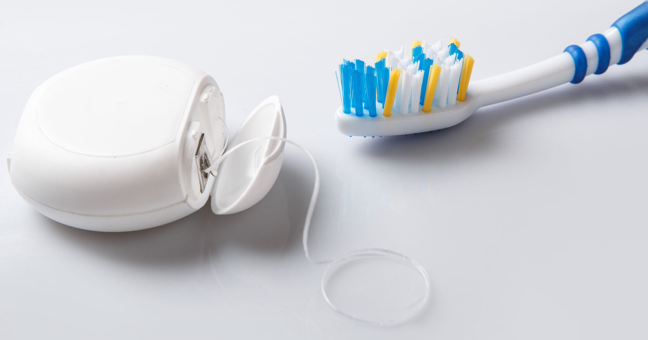 Close up of toothbrush and dental floss