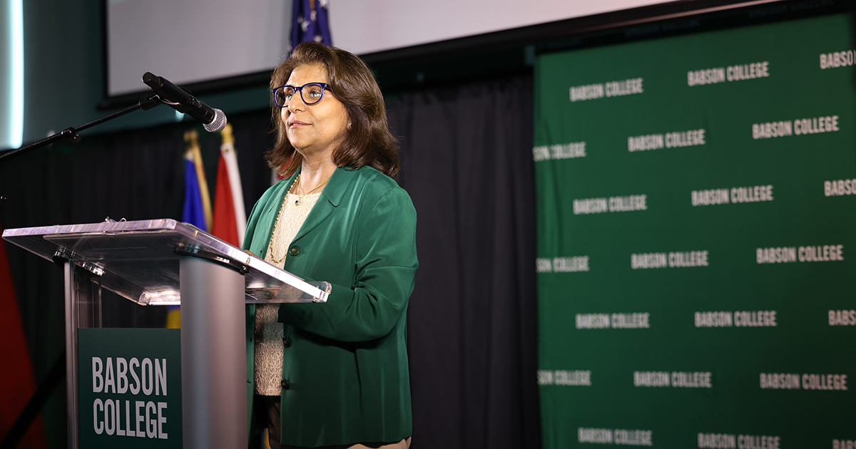 Woman who is the new Babson undergraduate dean stands at lectern at the College.