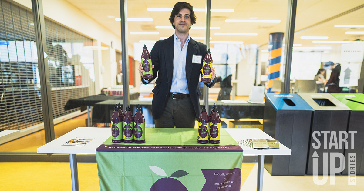 Man holds bottles of olive oil from his startup business.