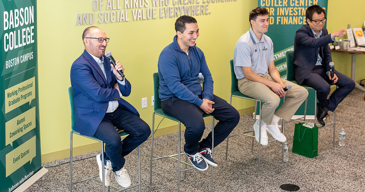 Peter Gordon MBA’96, Othmane Maacha MSF ’25, Jamie Modiano ’26, and Linghang Zeng sit on chairs before an audience