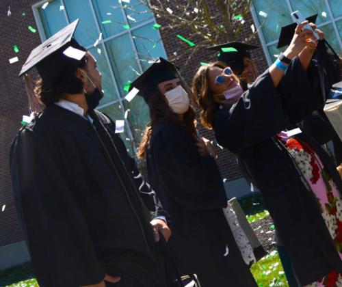 Students pose for a selfie following commencement.