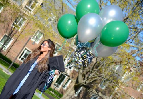 A student poses for a photo following commencement.