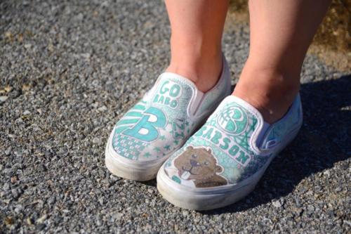 A student shows off her Babson College inspired sneakers.