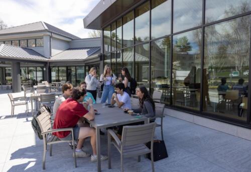 Students at the Herring Family Entrepreneurial Leadership Village patio. Photo by Marissa Langdon/Babson College